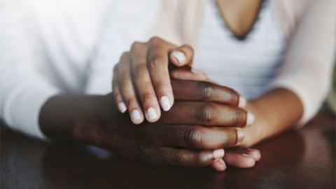 Generic close up shot of two people holding hands