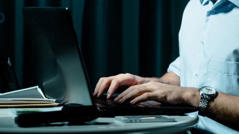 A generic image of a person's hands on a computer keyboard