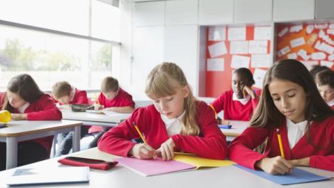 Students writing in classroom