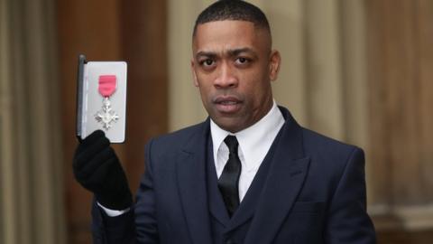 Wiley with his MBE in 2018