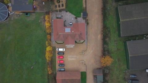 An aerial view of David Drews home, showing the driveway to the right, where it should have been built.