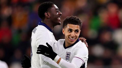 Divin Mubama and Rico Lewis celebrate an England goal