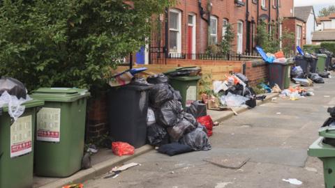 A file image of a litter-strewn street in Hyde Park, Leeds