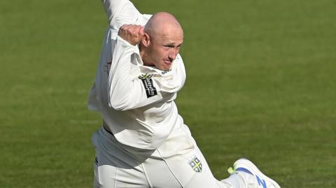 Durham spinner Callum Parkinson in his bowling action.