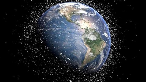 A graphic of the Earth showing debris surrounding it