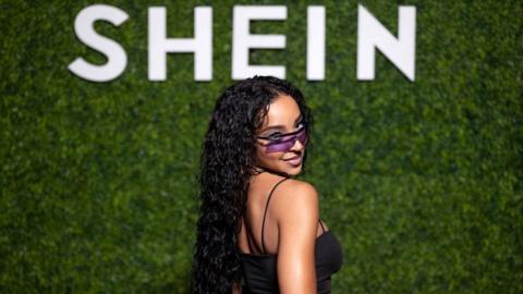 Singer Tinashe in front of Shein sign.