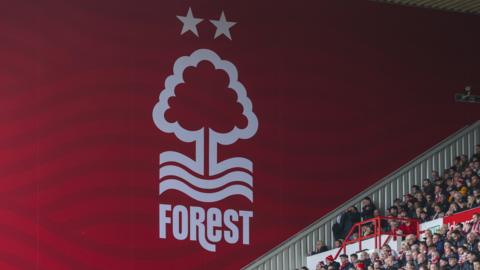 Fans watch a Premier League game from a stand at Nottingham Forest's City Ground