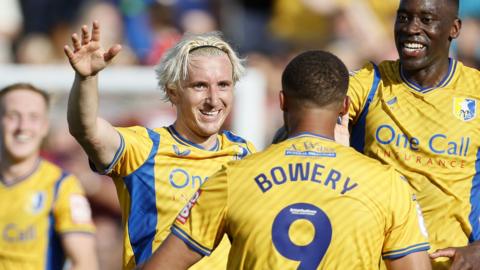 Aaron Lewis celebrates his spectacular goal against Accrington with his Mansfield team-mates