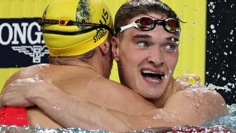 James Wilby embraces gold medallist Zac Stubblety-Cook after the men's 200m breaststroke