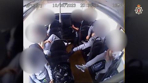 CCTV footage from a bus showing several youths with their faces blurred