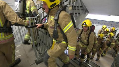 Firefighters walking up stairs