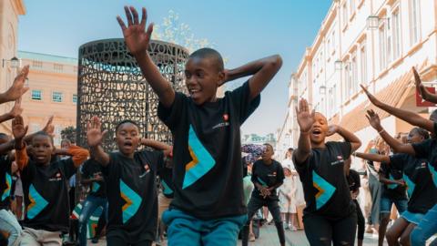 A choir of Zulu children singing and dancing