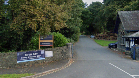 Elleray campus of Windermere School. Trees canopy over the entrance road to the private school.