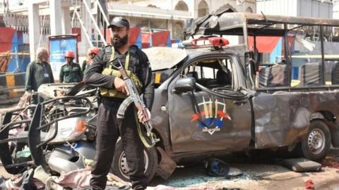Pakistani security officials inspect the scene of a suicide bomb attack that targeted a Police vehicle outside the Sufi Muslim Data Gunj Buksh shrine in Lahore, Pakistan, 08 May 2019.