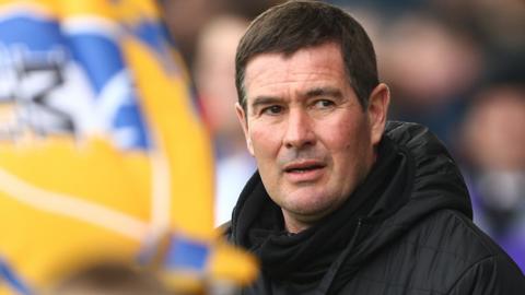 Mansfield Town boss Nigel Clough looks around before a game