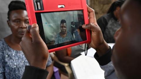 A Kenyan woman being registered for the Huduma Namba scheme in May last year