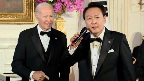 US president Joe Biden watches president of South Korea Yoon Suk Yeol sing