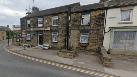 A pub, the Green Dragon Inn, at the end of a row of terraced houses in Thurgoland