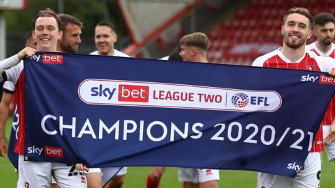 Cheltenham players celebrate winning League Two