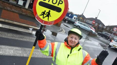 Elaine Dunn with her lollipop lady sign