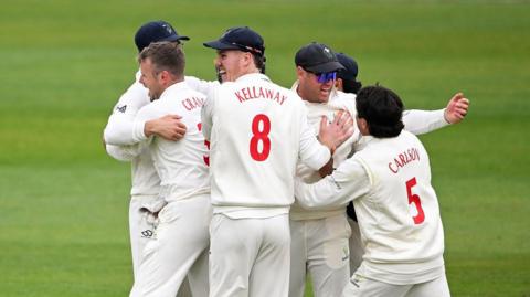 Glamorgan players celebrate a wicket against Hampshire
