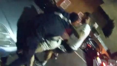 Officers restrain a man who doesn't realise they are police