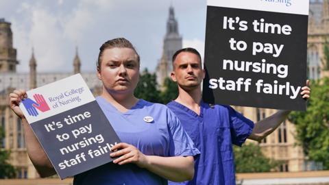 Nurses with placards outside the Royal College of Nursing (RCN) in Victoria Tower Gardens, London