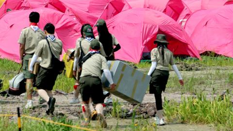 Attendees of the 25th World Scout Jamboree arrive at a scout camping site in the Saemangeum reclamation area in Buan, North Jeolla Province, on South Korea's west coast, on 1 August 2023