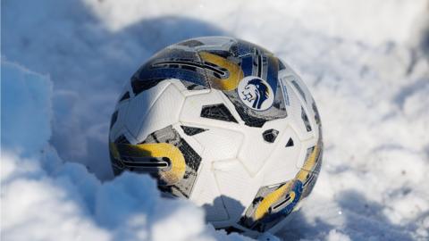 A football sits on snow