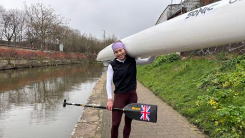 Beth Gill carrying her canoe by the Nottingham Canal