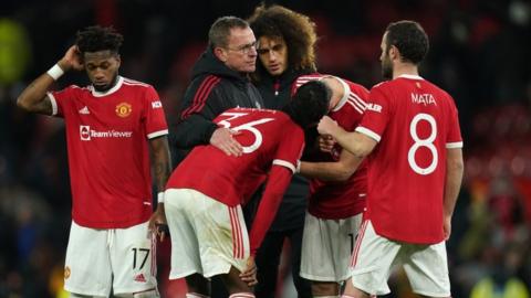 Manchester United"s Anthony Elanga is consoled by team-mates and manager Ralf Rangnick after missing the decisive penalty in the shoot-out after the Emirates FA Cup fourth round match at Old Trafford