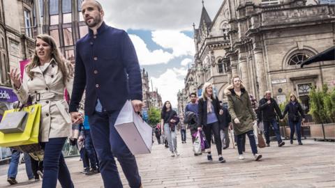 Couple walking along Buchanan Street in Glasgow