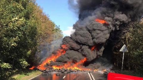 Tyres on fire in the road