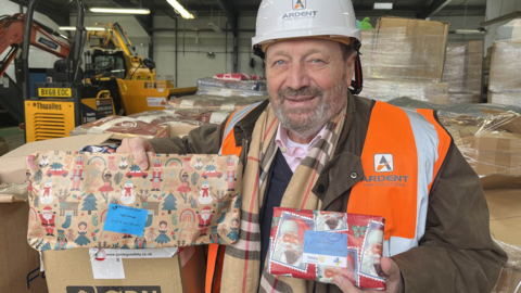 Brian Garner holding Christmas gifts