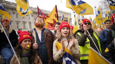 Striking members of the Public and Commercial Services Union (PCS) protesting outside Downing Street in London on 15 March