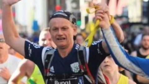 Blind Dave crosses a marathon finish line