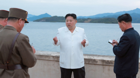 Kim Jong Un speaks to listening military officials