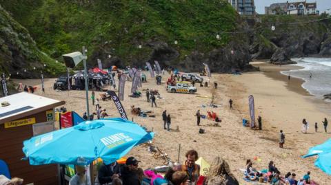 People on beach at surfing competition