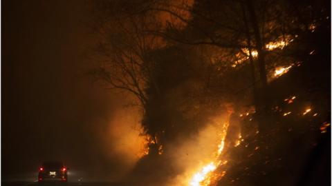 Fire erupts on both side of Highway 441 between Gatlinburg and Pigeon Forge, Tenn., Monday, 28 November 2016.