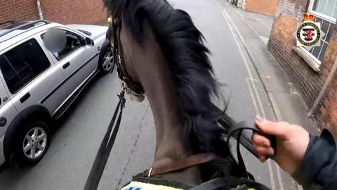 Mounted police follows a driver