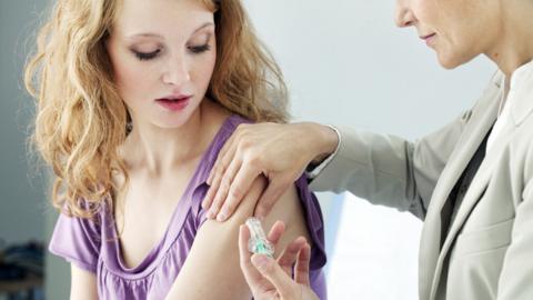 Woman getting a cervical cancer vaccine injection