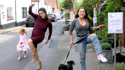 Two women silly walk