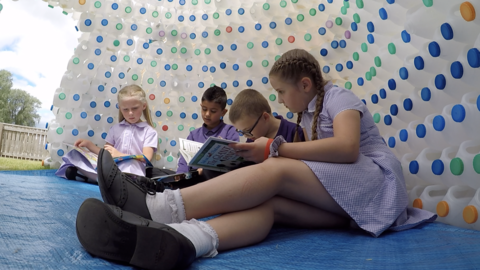 Children inside the empty milk bottle igloo