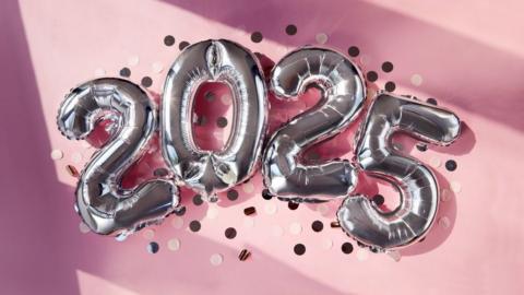 Silver number balloons spell out '2025'