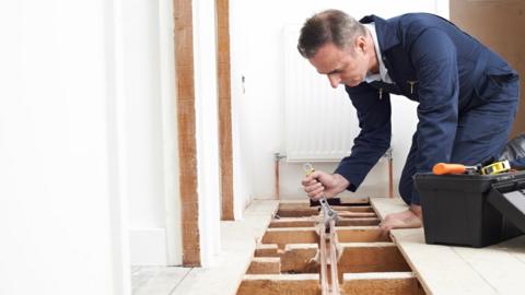 A stock image of a plumber