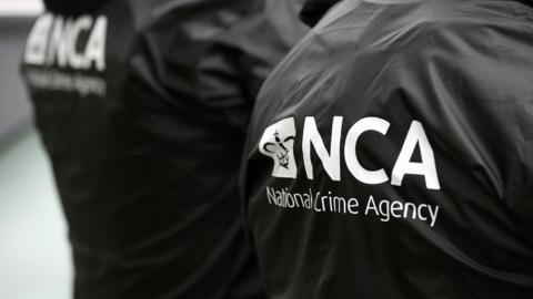 Stock image of a NCA logo on officers' jackets