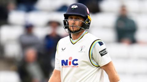 Joe Root walks off
