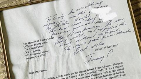 A framed letter written to President Jimmy Carter. In the top right, a handwritten reply from Carter has been written on the letter itself, and on the left is the former President's typed address. The beginning of Dr Stacey's letter is also visible. 