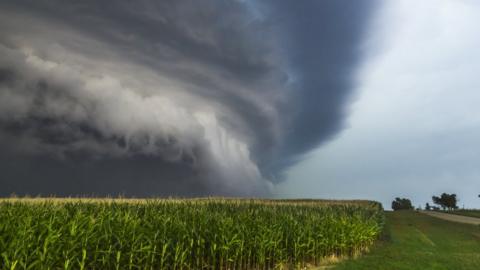 Towering grey cloud with a large, shelf-shaped hanging area of cloud emerging from the base