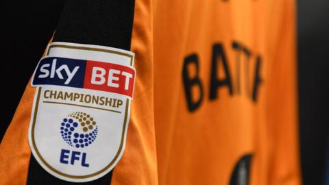 Close up of a Hull City shirt showing the Championship badge